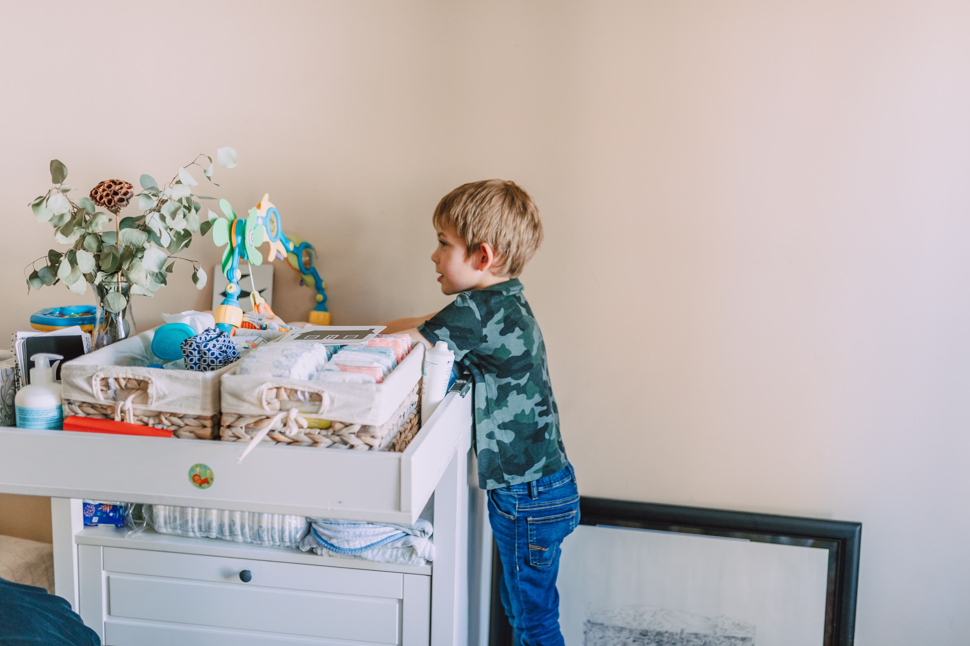 Kind bij commode met luiers en billendoekjes